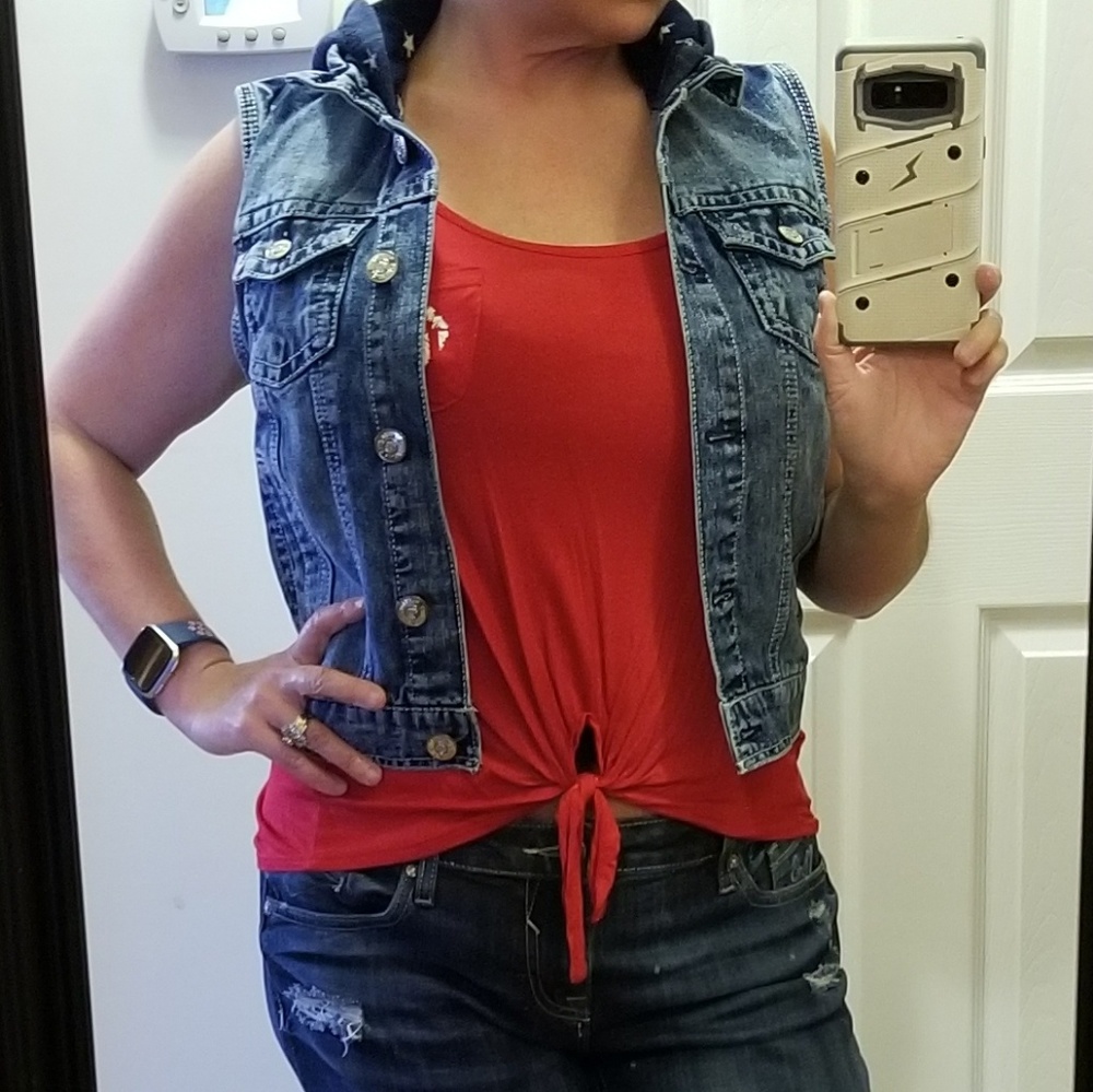 Wallflower denim vest and red tank top.